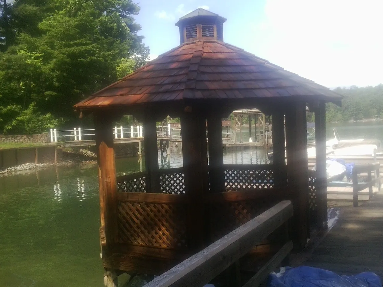 Cedar shake gazebo roof rebuilt on a lake dock in Lafitte